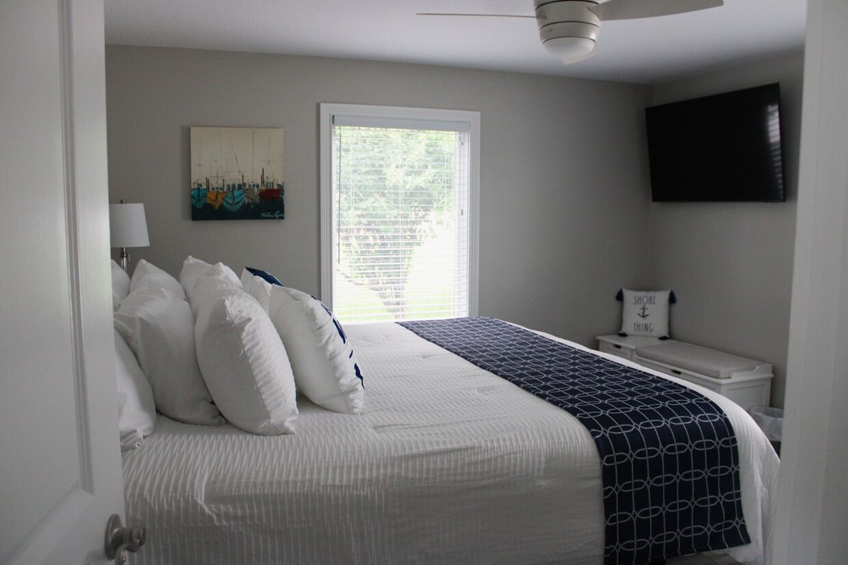 The primary bedroom features a cozy setup with a smart TV; perfect for unwinding at the end of the day.