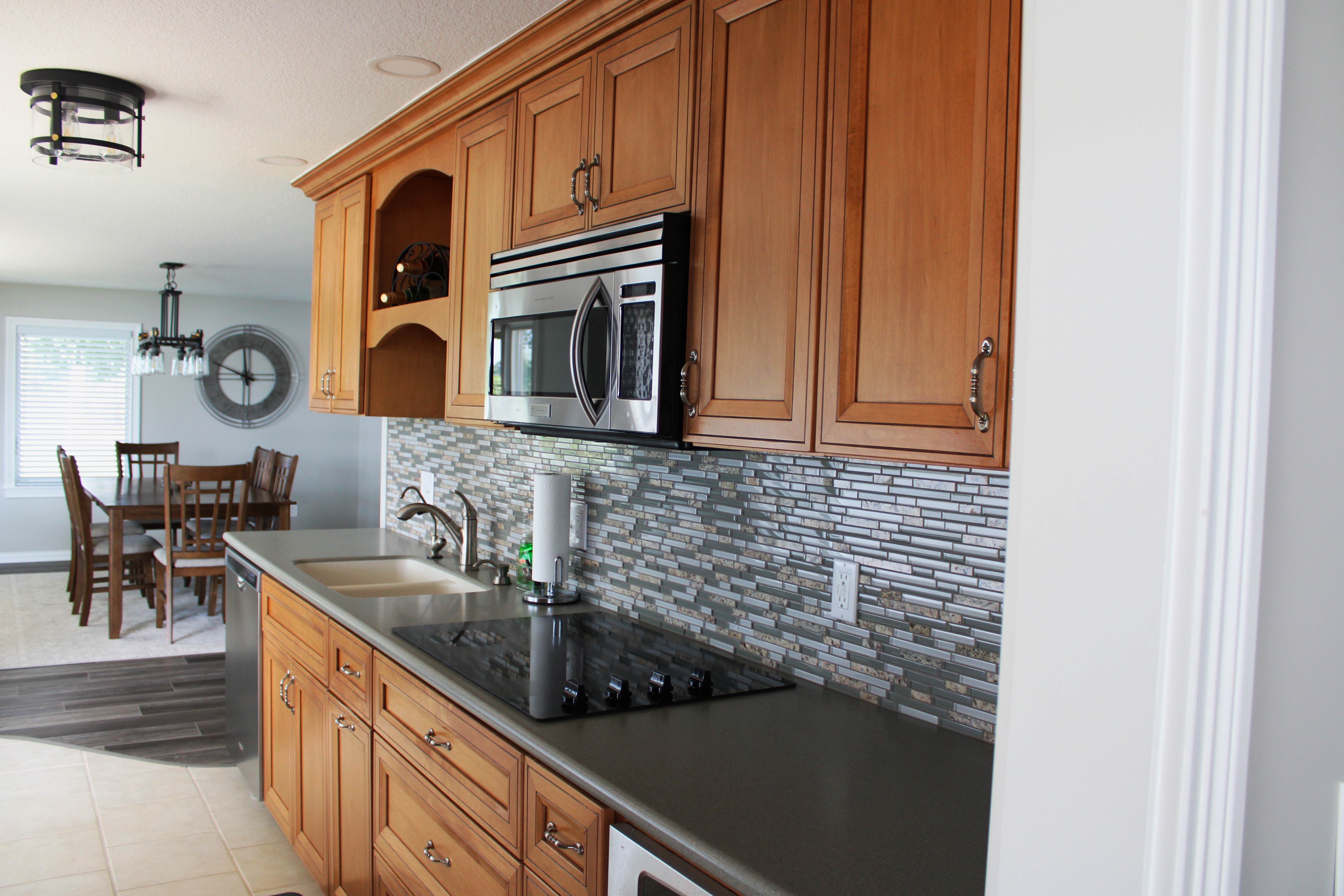 Fully stocked kitchen with cookware and utensils at lakefront home.